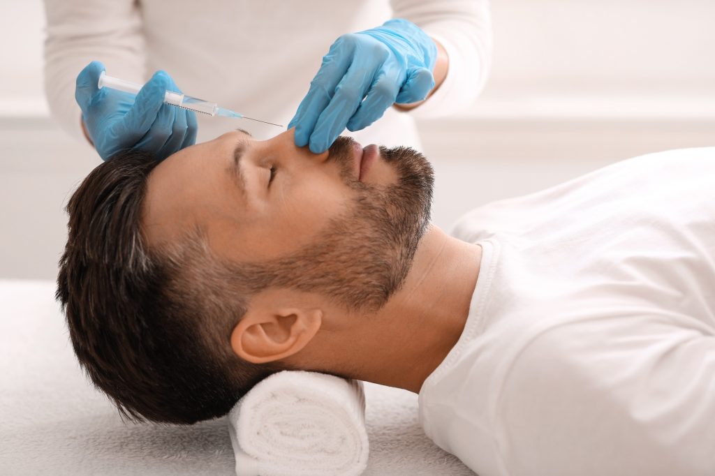 Nonsurgical rhinoplasty for handsome man at aesthetic clinic