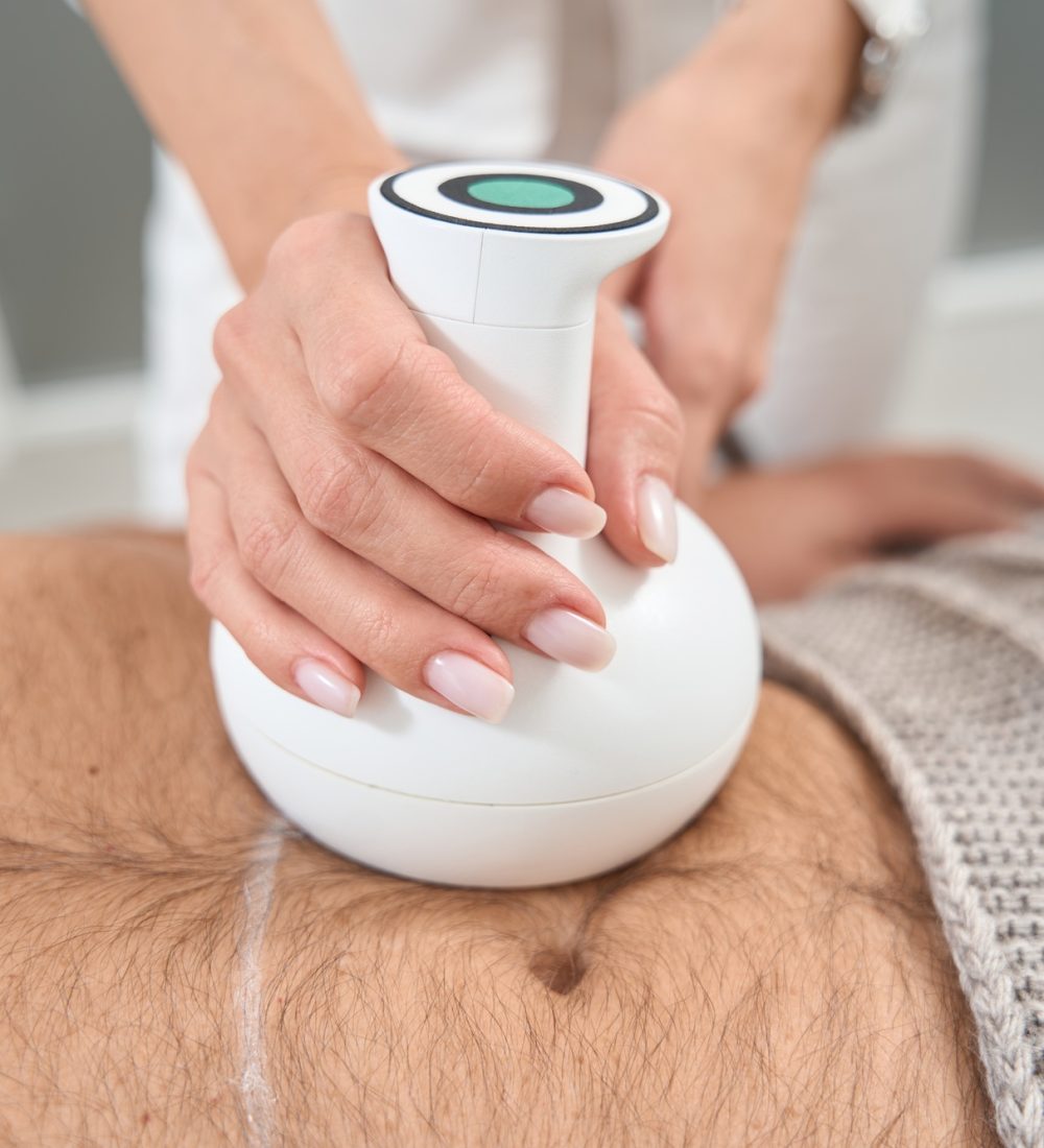 Body shaping specialist performs a procedure on a patient