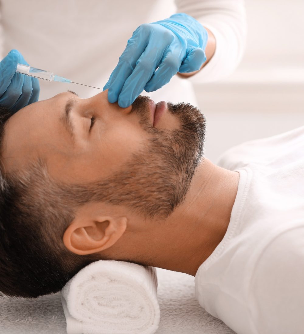 Nonsurgical rhinoplasty for handsome man at aesthetic clinic